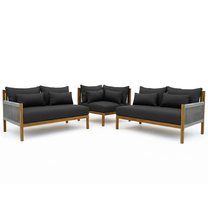 Tavi 5 Seater Solid Timber L Shape Outdoor Sofa features two armless loveseats and a corner chair, with low wooden frames, black cushions, and woven rope detailing, forming a stylish modular seating arrangement.