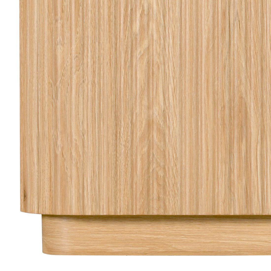 Close-up of the lower part of a light wood cabinet on white background