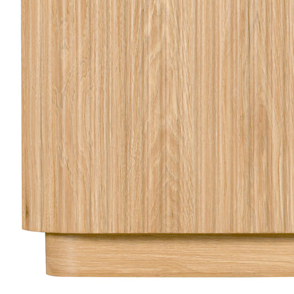 Close-up of the lower part of a light wood cabinet on white background