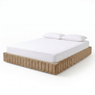 Beige upholstered king bed with white mattress and pillows on white background