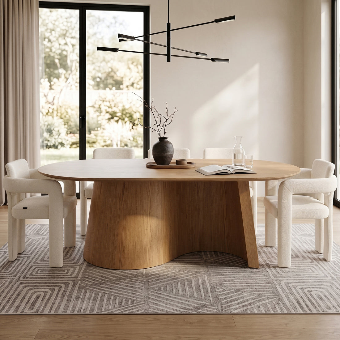 Oval wooden dining table styled in a modern room with chairs