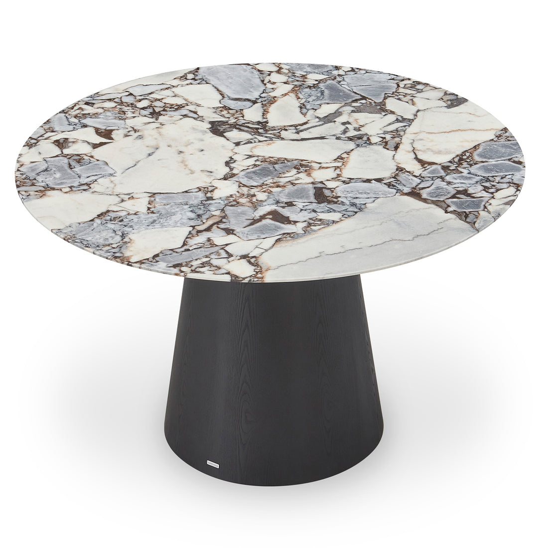 Dina 120cm Round Marble Dining Table features a white and gray veined marble top on a matte black tapered cylinder base, with a small metal plaque near the bottom.