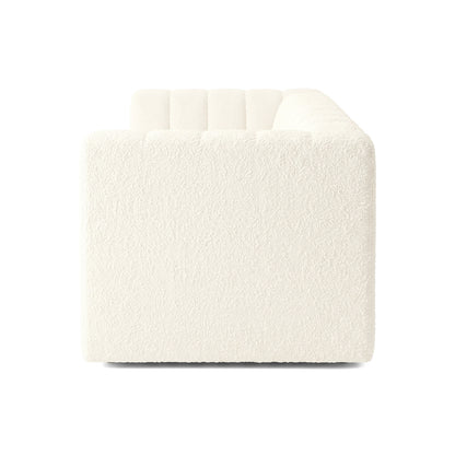 Side view of a cream upholstered sofa on a white background