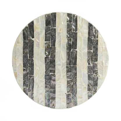 Round decorative plate of mosaic shell segments on white background