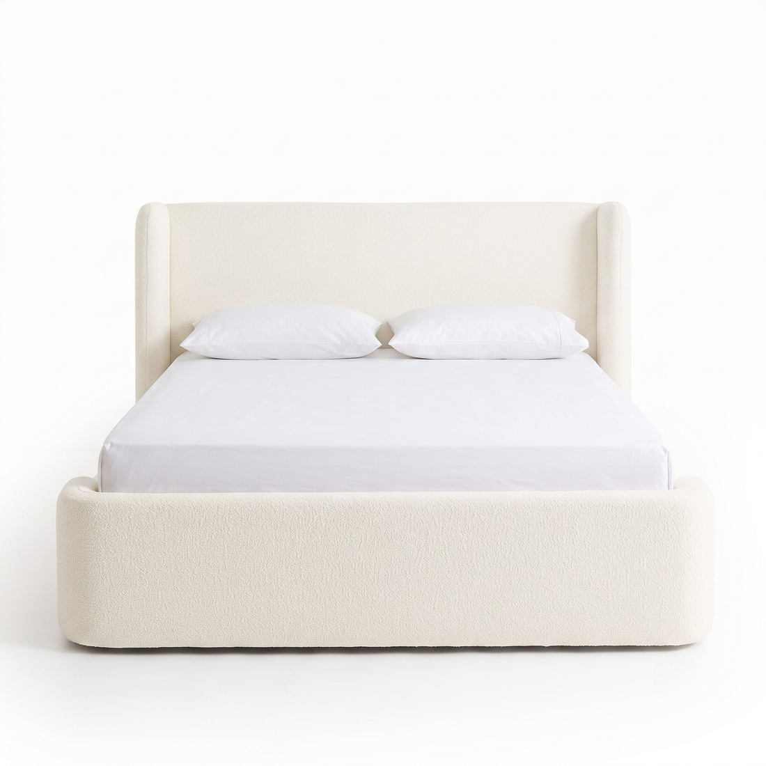 Full upholstered bed on a white background with pillows