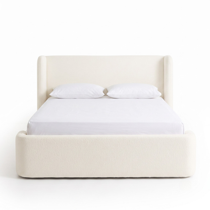 Full upholstered bed on a white background with pillows