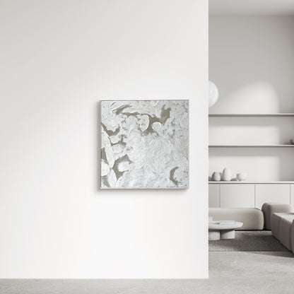 Luma Framed Canvas Wall Art 105 x 105cm in White, featuring a textured abstract design, hangs on a white wall above a beige sofa, complemented by a modern concrete coffee table.