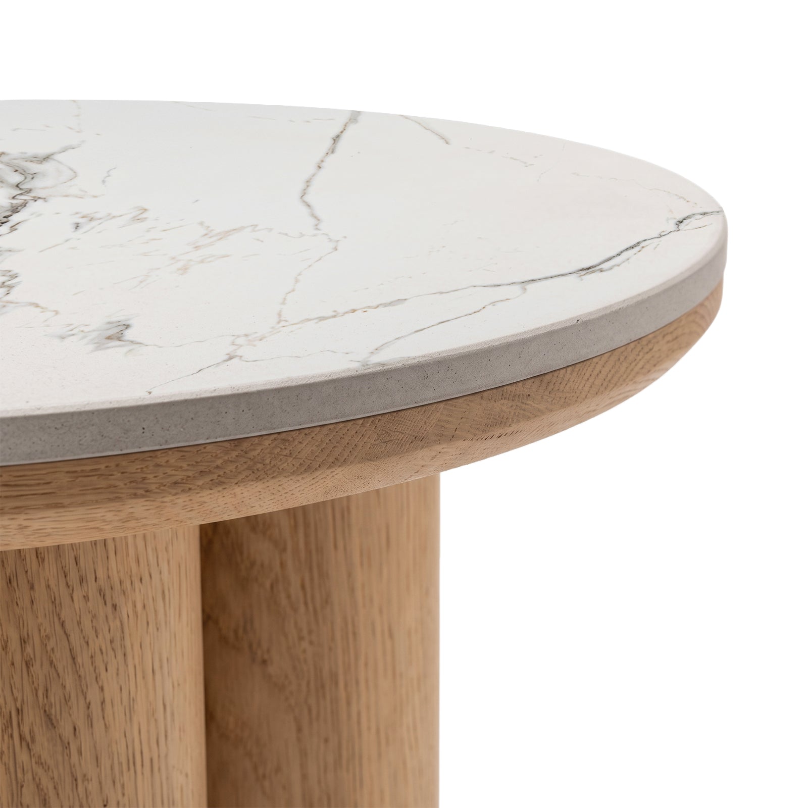Close-up partial view of a round table with marble-look top and wooden base