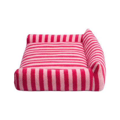 Pink and red striped rectangular pet bed with raised sides on a white background