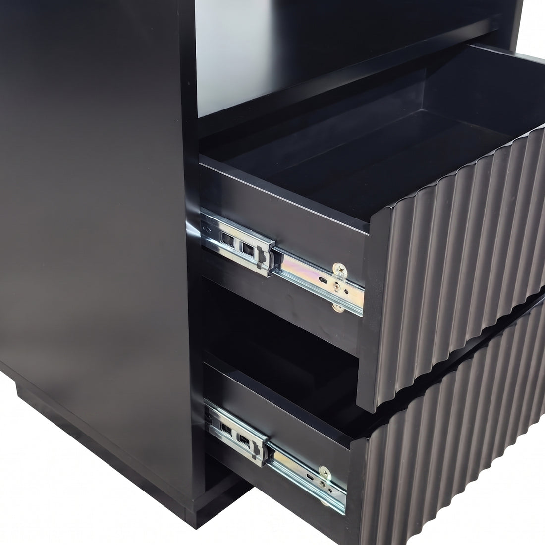 Close-up of partially opened drawers on a black cabinet against a white background