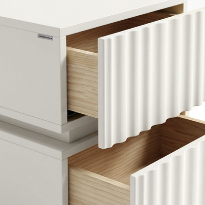 Close-up of open drawers on a white textured furniture piece.