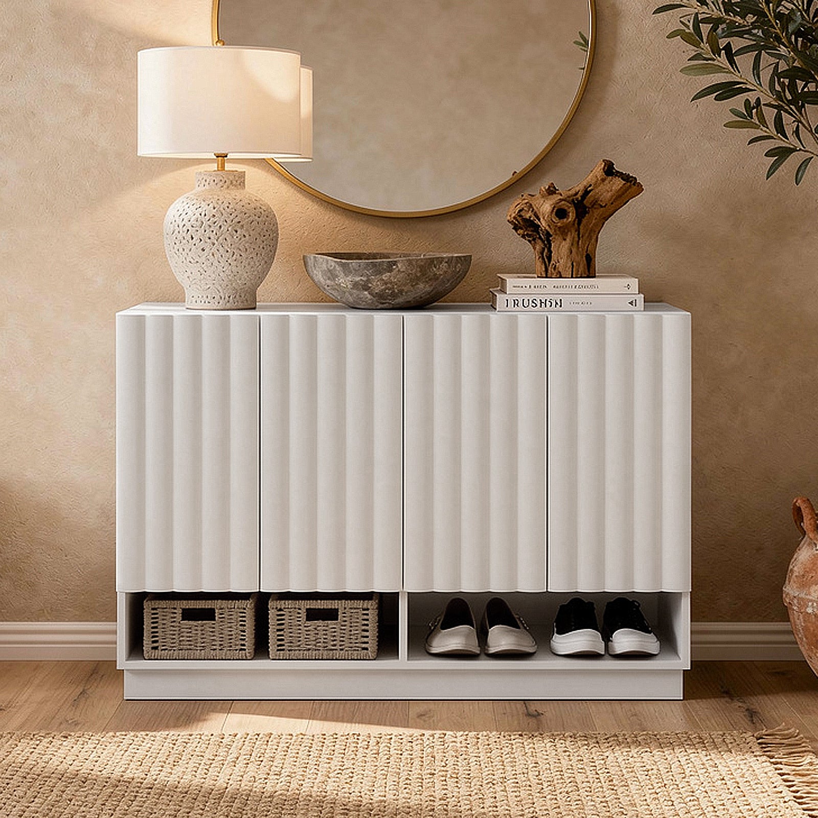 White storage cabinet in a neutral-toned living area styled with lamp, mirror, decorative accessories