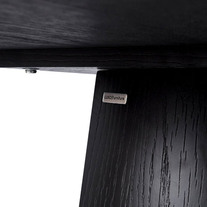 Close-up of the underside and leg joint of dark wood furniture with a brand plate