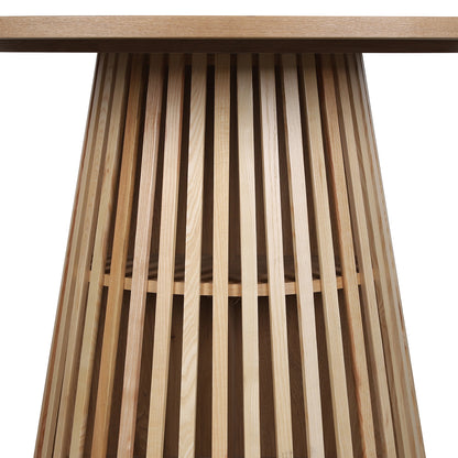 Riri 120cm Round Fluted Wood Dining Table in Oak features a conical base of vertical wood slats supporting a round tabletop, showcasing a sculptural design ideal for stylish, compact dining spaces.