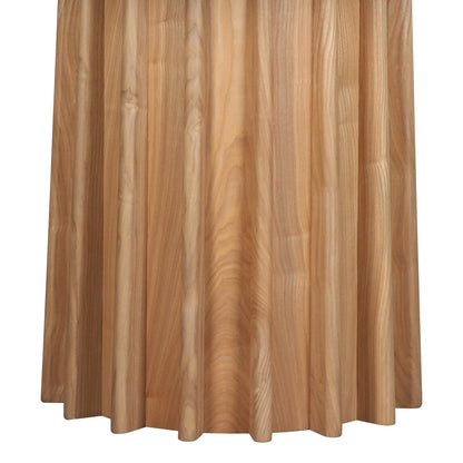 Gabi 120cm Marble Look Dining Table in Oak features a sculptural, drum-shaped base with vertical wooden slats, showcasing natural wood grain against a plain background.