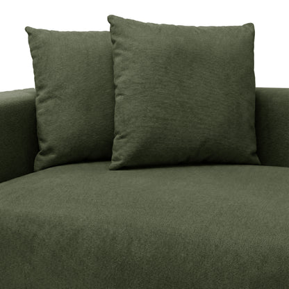 Partial view of green upholstered seating with back cushions on white background