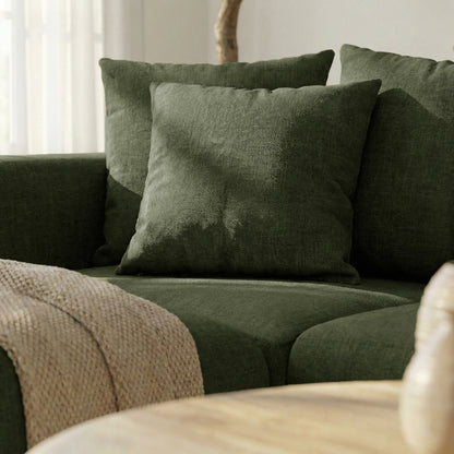 Close-up of green sofa section with cushions in room