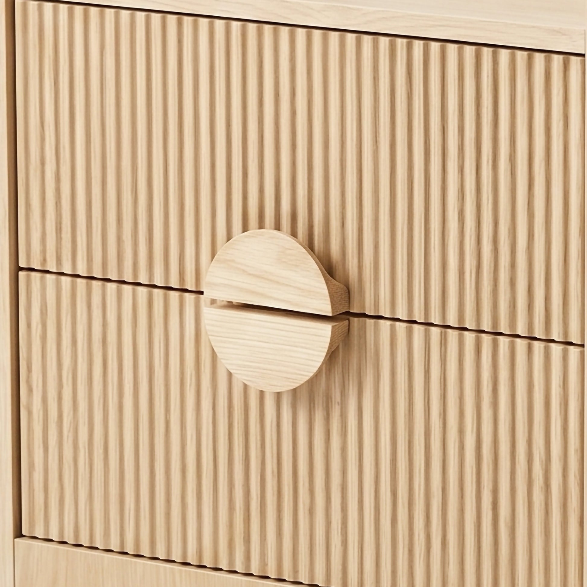 Close-up of ribbed wood drawer fronts with round wooden handle