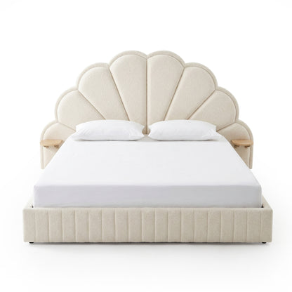 Upholstered scallop headboard bed with white bedding on white background