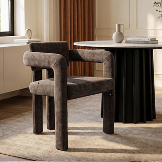 Modern dark brown upholstered chair in a styled dining room