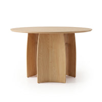 Round wooden dining table on a white background