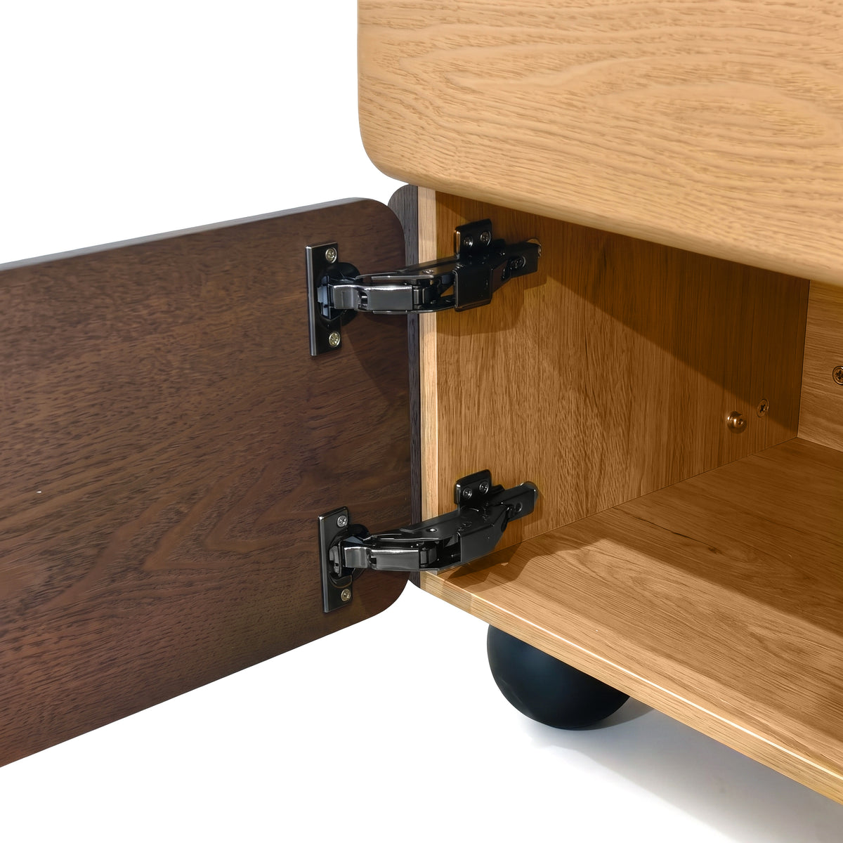 Close-up of the inside of a wooden cabinet with open door and visible hinges