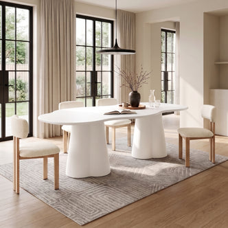 Modern white dining table with chairs in a bright dining room