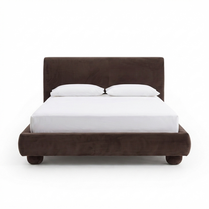 Full upholstered dark brown bed with white bedding on a white background