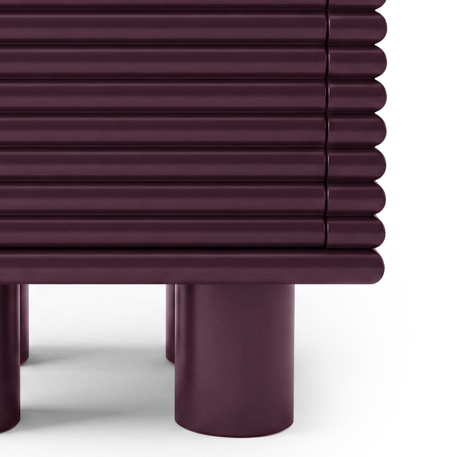 Close-up of base and ribbed detail of burgundy side table on white background