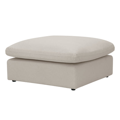 Square light beige ottoman on a white background with a thick cushion top.