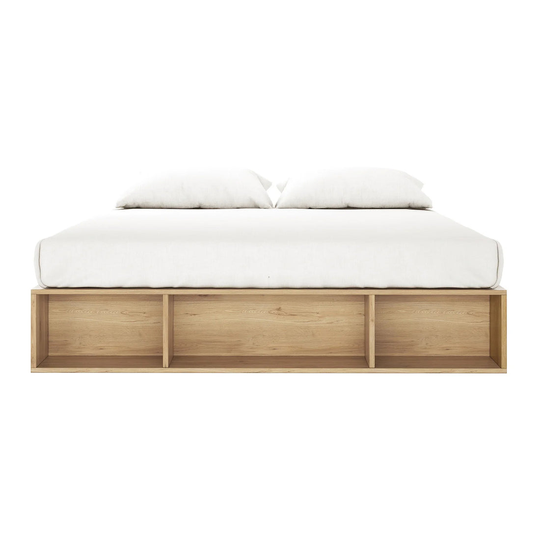 Eulalia King Platform Bed Base with Drawers in Oak features a sleek, low-profile design with a light wood base, white mattress, and pillows, plus three open shelves for storage.