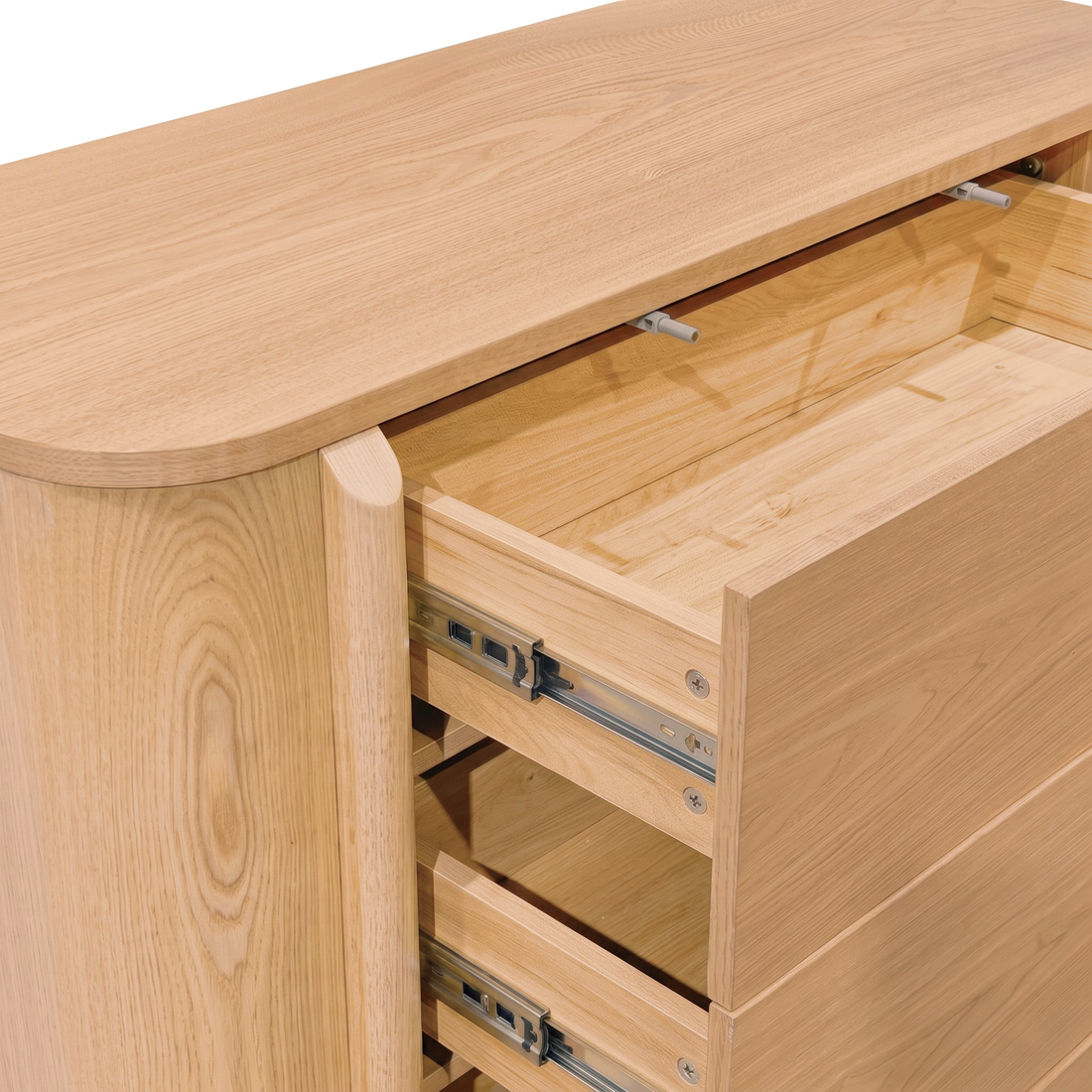 Close-up of a light wood dresser with partially opened drawers