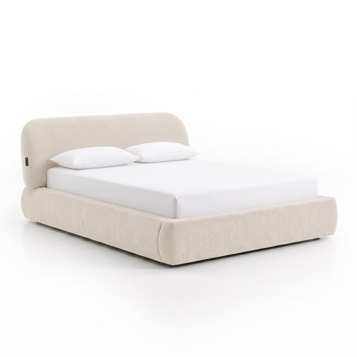 Cream upholstered bed photographed on a white background