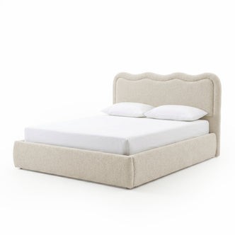 Modern upholstered bed with scalloped headboard on white background