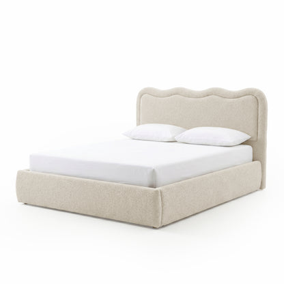 Modern upholstered bed with scalloped headboard on white background
