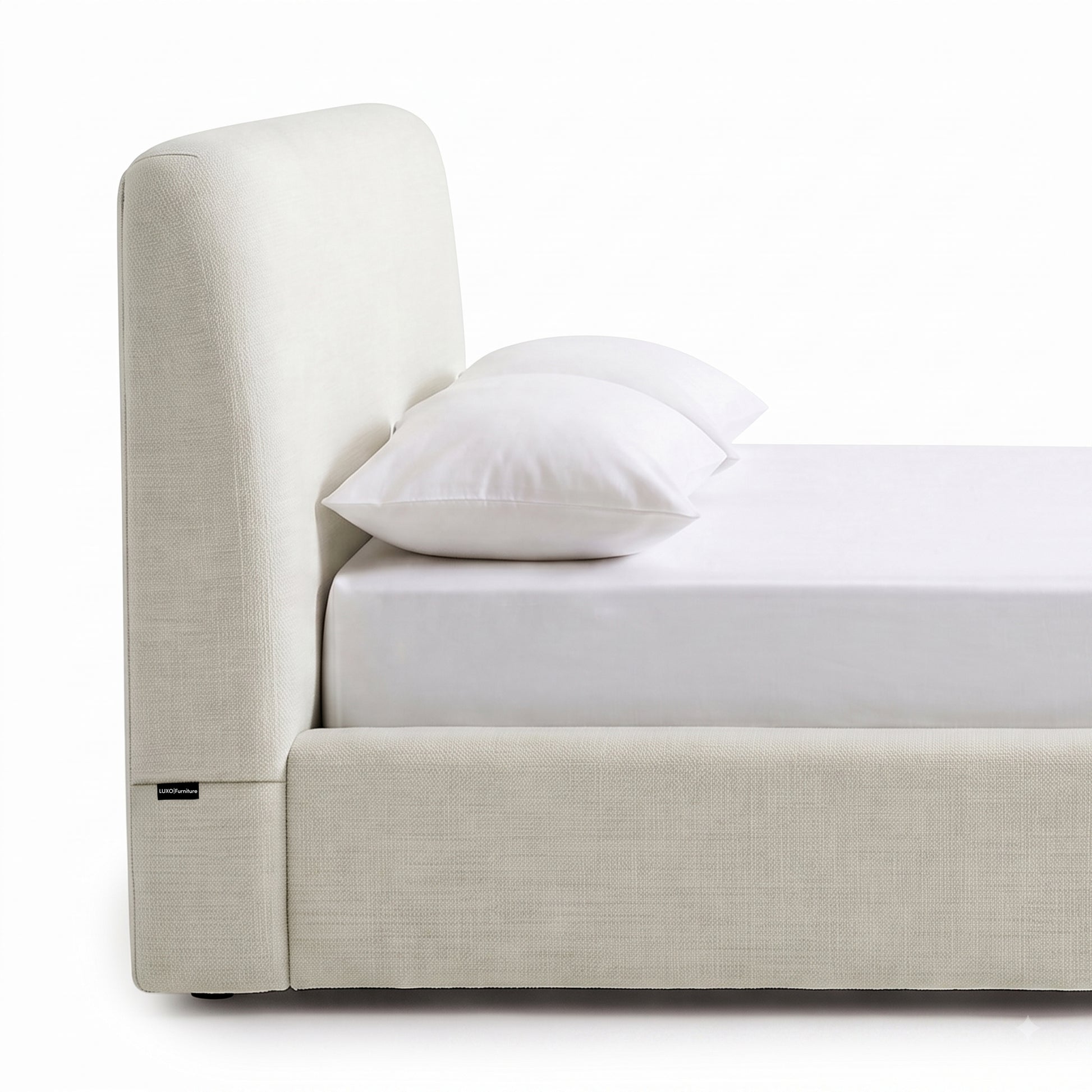 Side view close-up of a modern upholstered bed on a white background