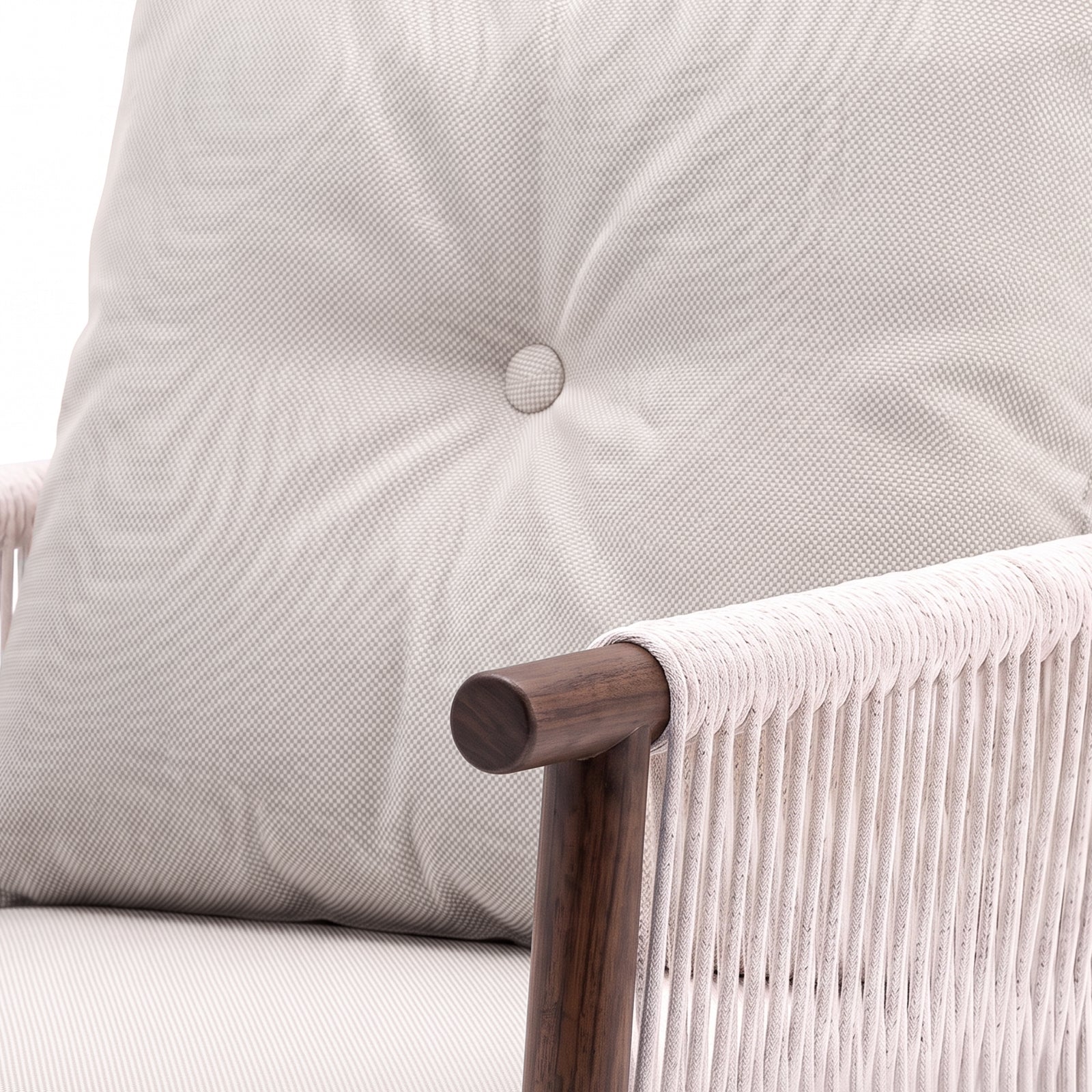 Close-up of a chair armrest, cushion, and woven side detail on a white background