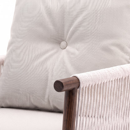 Close-up of a chair armrest, cushion, and woven side detail on a white background