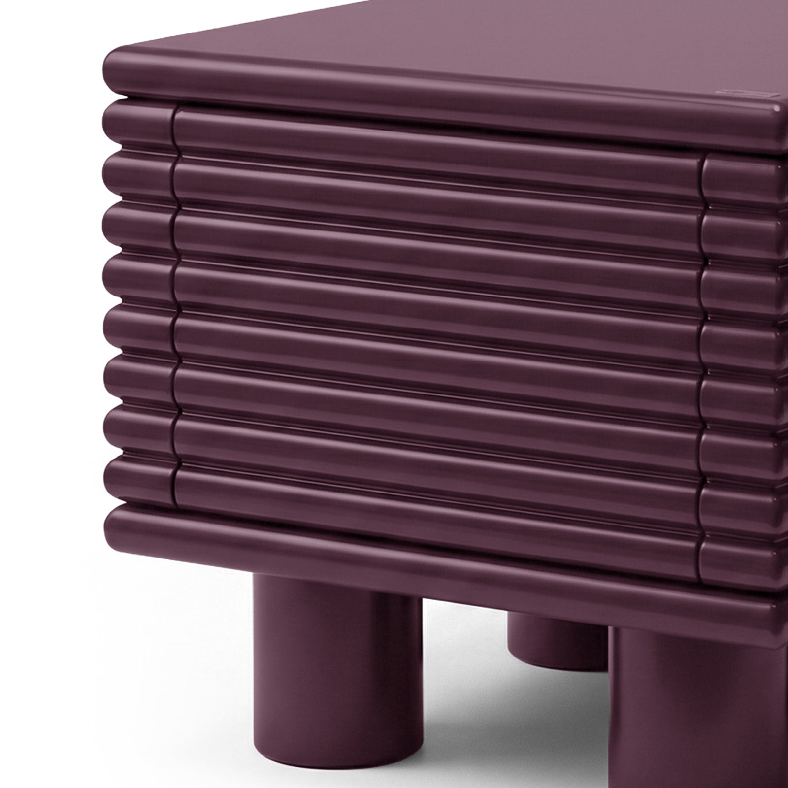 Close-up of top corner and ribbed surface of plum side table