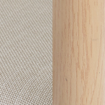 Close-up of beige woven fabric next to light wood on a furniture piece