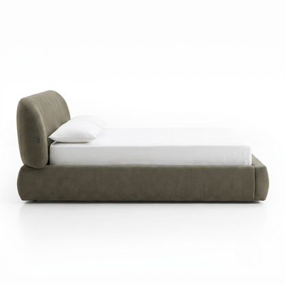 Side view of upholstered platform bed on a white background