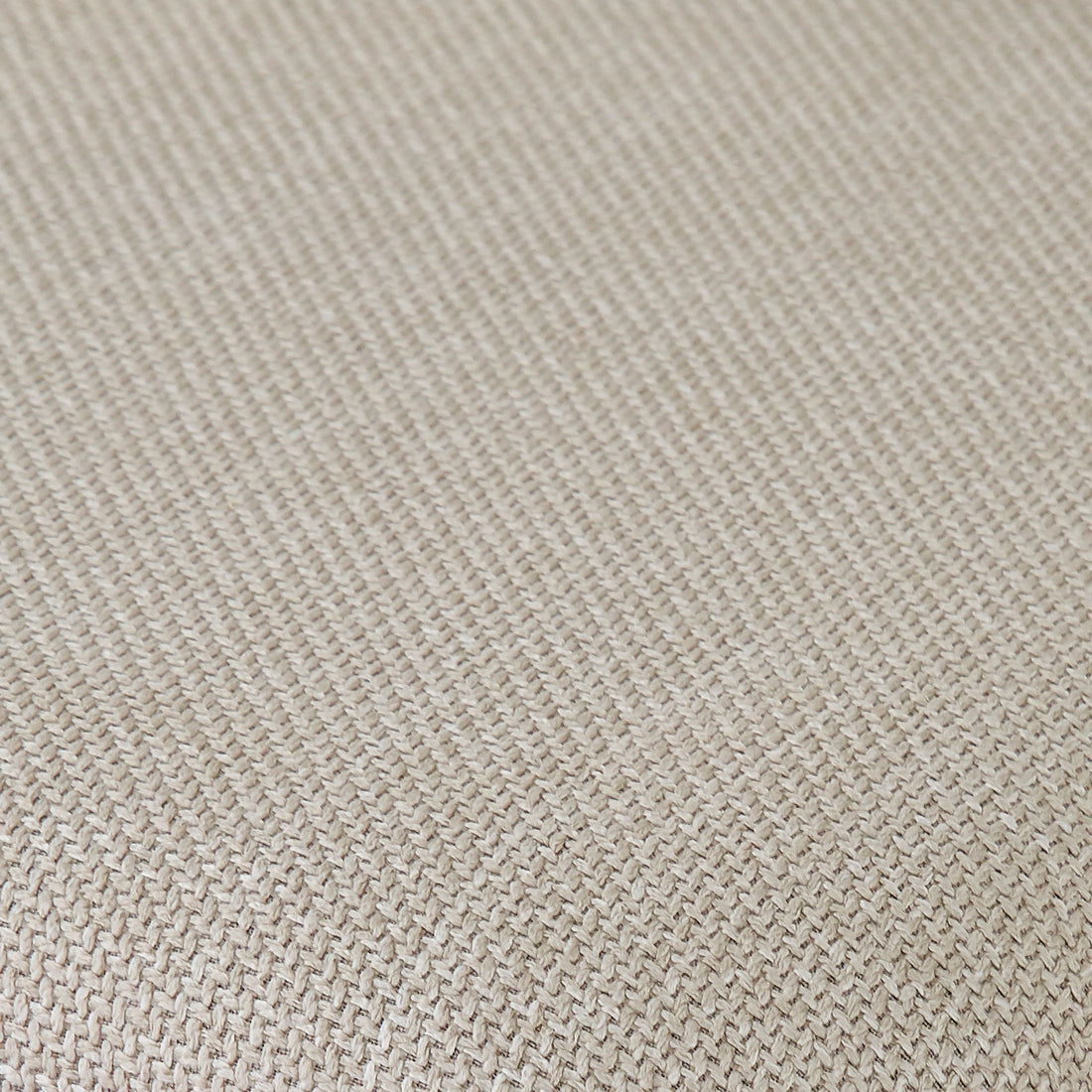Extreme close-up of beige woven fabric texture.