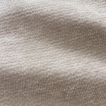 Close-up macro view of beige woven fabric texture.
