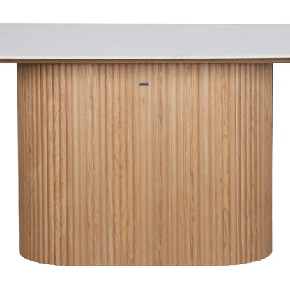 Aeris 180cm Marble Look Dining Table With Wood Base features a curved, fluted-wood base and a smooth white top, embodying a mid-century-modern aesthetic ideal for dining or reception areas.