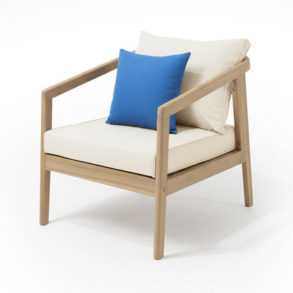 Modern-style armchair from the Delva 4 Seater Hardwood Acacia Outdoor Sofa Set in Cream, featuring a light wood frame, off-white cushions, and a bright blue throw pillow.