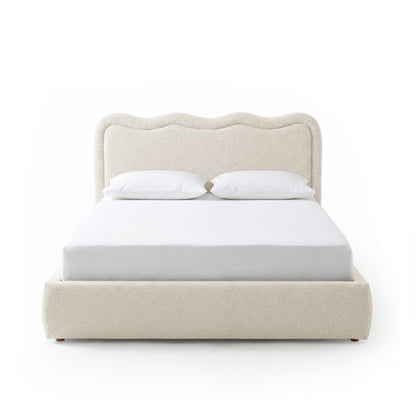 Front view of upholstered bed with wavy headboard on white background
