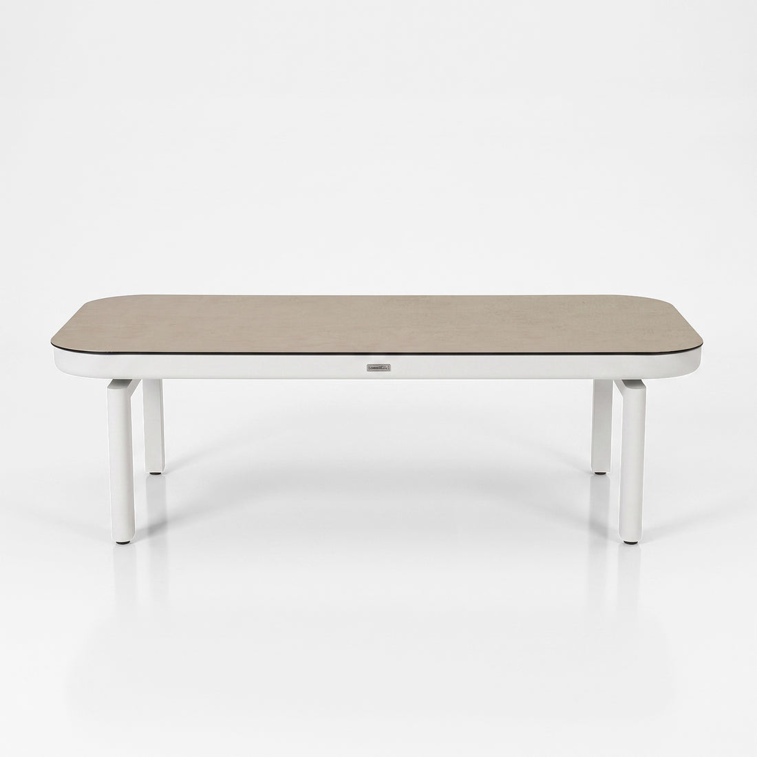 Modern rectangular table with rounded edges on a white background.