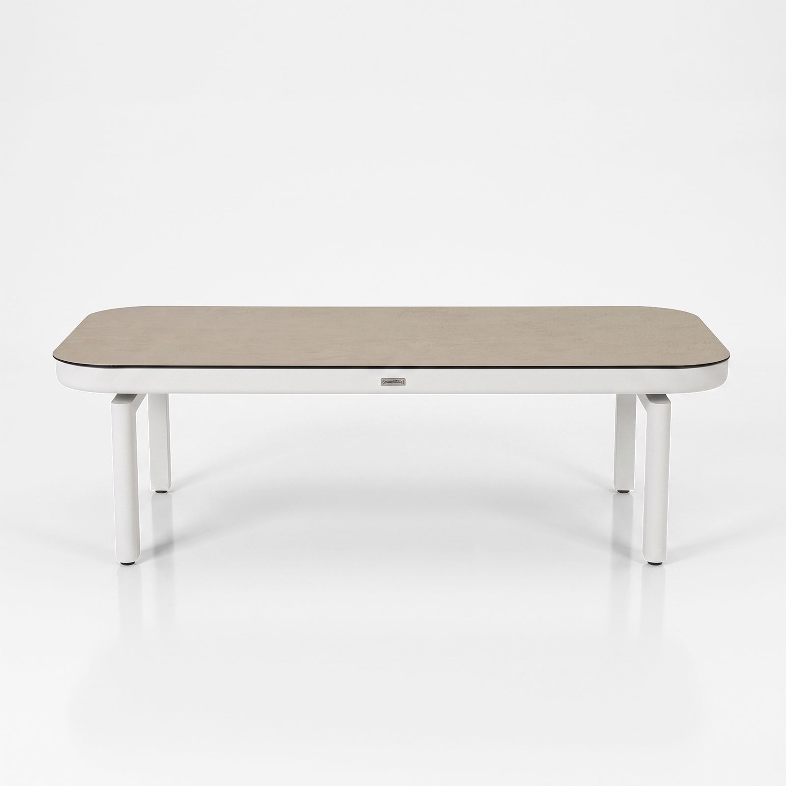 Modern rectangular table with rounded edges on a white background.
