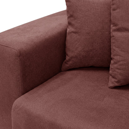 Close-up of sofa armrest and seat area in reddish-brown fabric on white background