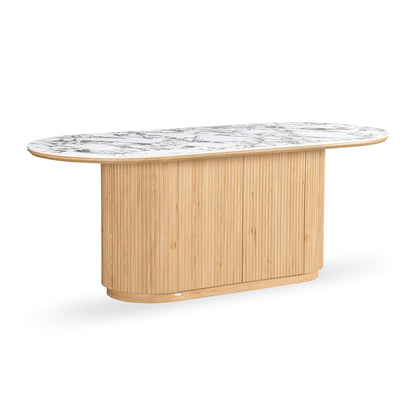 Rectangular dining table with rounded edges, marble-look top, and ribbed wood base on a white background